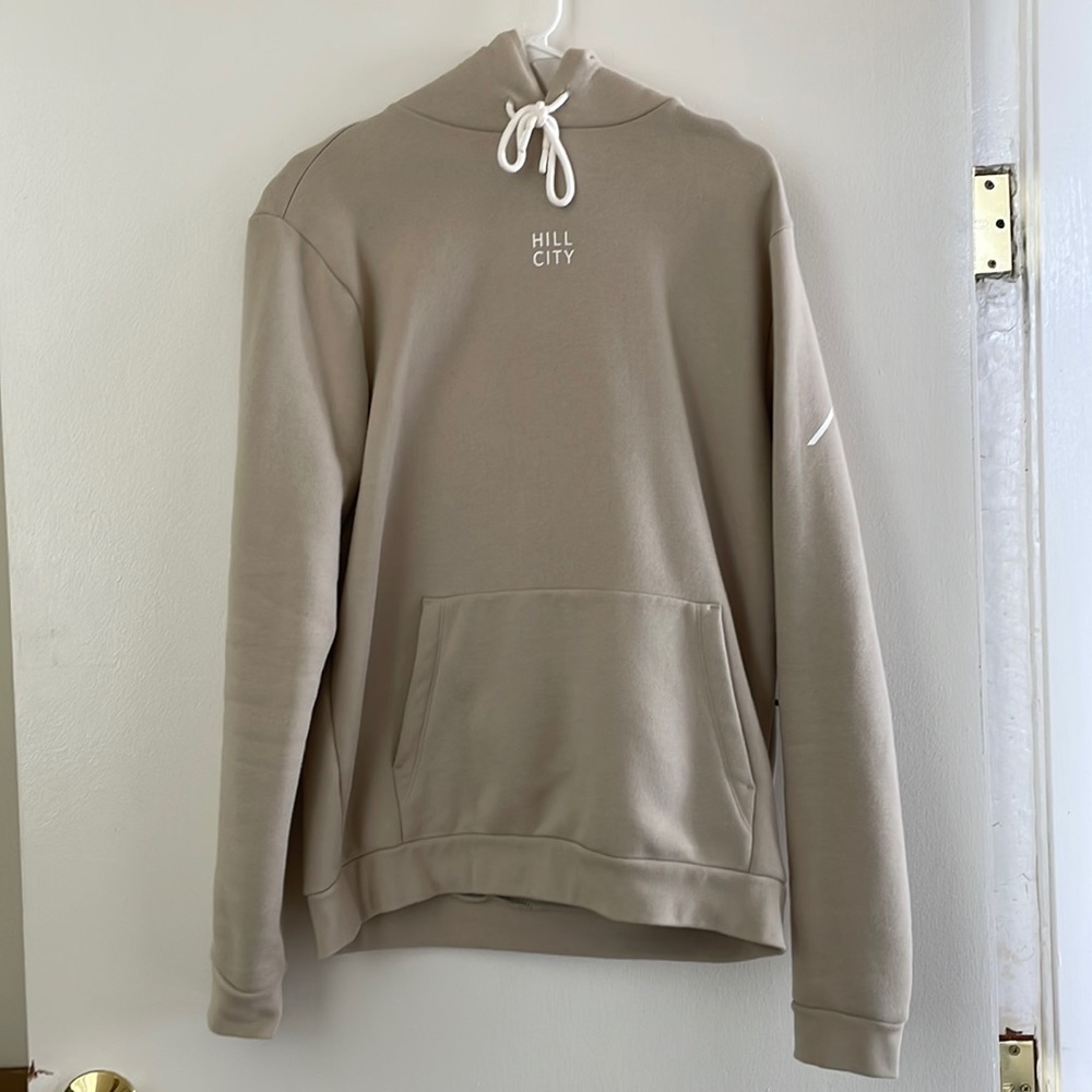 Hill City cream pullover hoodie with left side zip up pocket